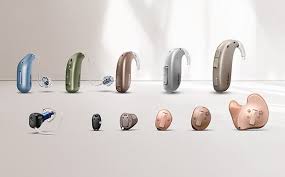 Range of modern hearing aid styles — behind-the-ear (BTE), receiver-in-canal (RIC), in-the-ear (ITE) and custom in-the-canal models in assorted colours available at Poorvam Hearing