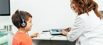 Child undergoing a paediatric hearing assessment with an audiologist at Poorvam Hearing, part of cochlear implant and auditory verbal therapy support